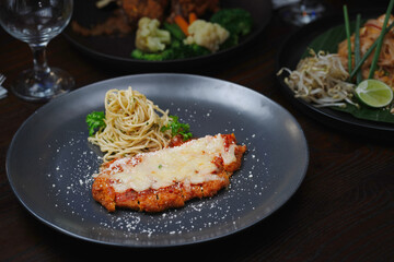 Classic Chicken Parmesan with Spaghetti Aglio e Olio and Broccoli Garnish