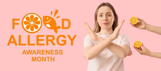 Young woman showing stop gesture and hands with orange on pink background. Food Allergy Awareness Month