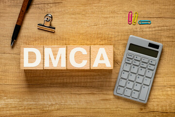 There is wood cube with the word DMCA. It is an abbreviation for Digital Millenium Copyright Act as...