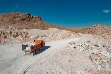 Truck carrying raw stuff at mining quarry