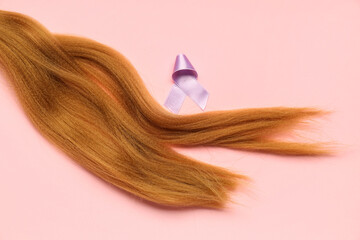 Red hair strand for donation with purple awareness ribbon on pink background