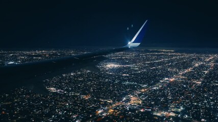 A breathtaking view from an airplane window at night, featuring the vibrant and bright city lights below as the plane begins its descent - Powered by Adobe