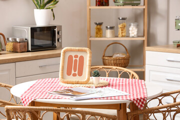 Dining table with magazines and picture in kitchen