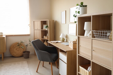 Interior of living room with workplace and shelf units