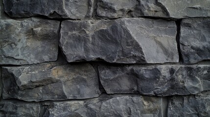 Fototapeta premium Mason applying cement to secure stone blocks for a decorative wall. Featuring craftsmanship and detail