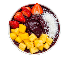 Colorful acai bowl topped with strawberries mango pineapple and shredded coconut