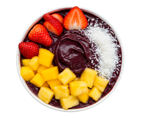 Colorful acai bowl topped with strawberries mango pineapple and shredded coconut