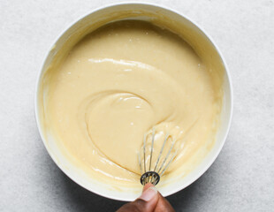 top view of vanilla cake batter being mixed, process of making vanilla cake
