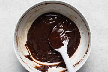 Overhead view of Dark chocolate ganache, chocolate ganache for covering and decorating cakes