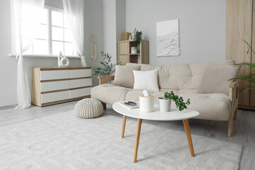 Interior of living room with sofa, table and commode