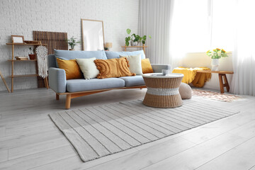 Interior of modern light living room with sofa and table