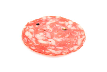 One slice of tasty smoked sausage with spices on white background
