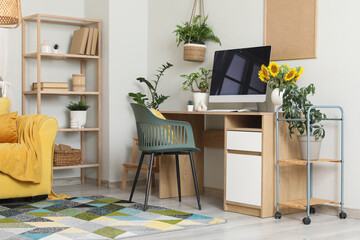 Interior of living room with workplace and plants