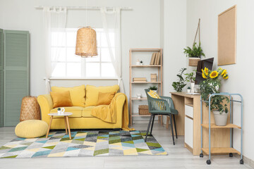 Obraz premium Interior of living room with workplace, sofa and plants