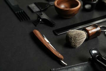 Many different barber's tools on black table, closeup
