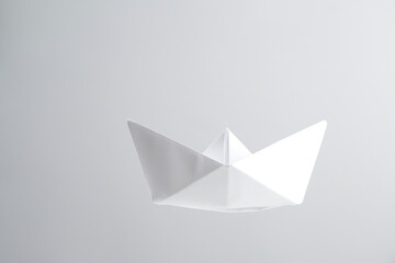 Beautiful paper boat on light grey background