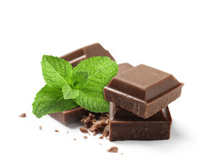 Milk chocolate pieces and mint leaves on white background