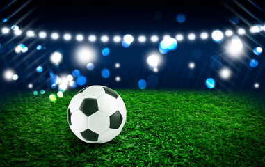 Naklejka premium Soccer ball on green grass at football stadium, space for text