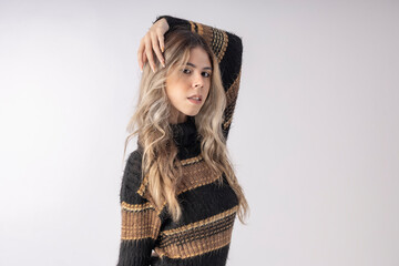 young woman wearing a blouse and skirt in studio photo with infinite background, making funny poses