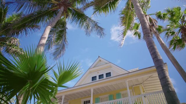 Experience breathtaking ocean views at this beautiful beachfront house in Key West, surrounded by palms and a vibrant sky, embodying Floridas tropical paradise for a perfect getaway