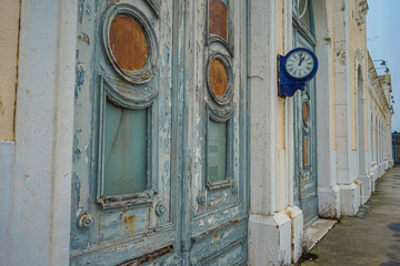 Wall clock in the dilapidated building of the old railway terminal station in the city of Barreiro, Portugal. 