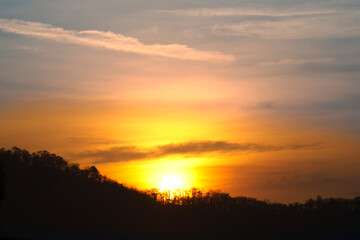 The sun is shining in the morning over the mountaintops.