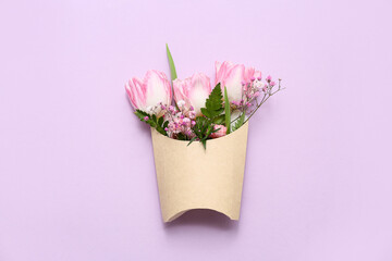 French fries paper box with beautiful flowers on lilac background