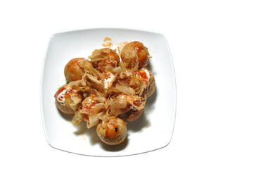 Takoyaki is a typical Japanese food in the form of balls and made from wheat flour dough filled with octopus.