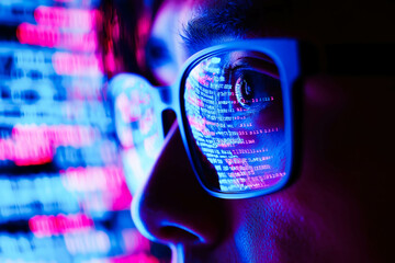 Computer, code hologram and man thinking of data analysis, night cybersecurity and software coding overlay. Programmer or person in glasses reading html script, programming or cybersecurity research