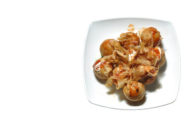 Takoyaki is a typical Japanese food in the form of balls and made from wheat flour dough filled with octopus.