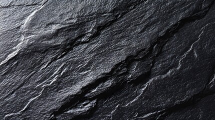 Textured black slate surface with natural stone pattern, showcasing minimalist elegance and raw beauty
