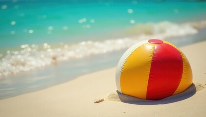 Obraz premium Deflated beach ball half-buried in warm sand close to turquoise water , shoreline, vacation