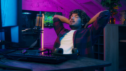Arabian Indian Latino American man male guy keyboard typing achievement goal computer streamer gamer programmer player technology cyber sport esport finish play video game online gambling relax home © Yuliia
