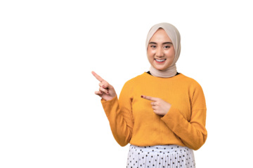 Beautiful cheerful Asian girl wearing hijab pointing finger at empty copy space isolated on transparent background