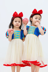 Playful cute twin little girls on white background