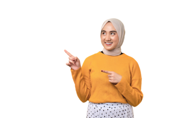 Beautiful cheerful Asian girl wearing hijab pointing finger at empty copy space isolated on transparent background