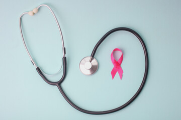 Pink Ribbon And Stethoscope On Light Blue Background Support People With Breast Cancer.