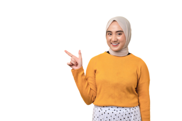 Beautiful cheerful Asian girl wearing hijab pointing finger at empty copy space isolated on transparent background
