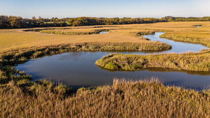 Aerial drone river winding through marsh