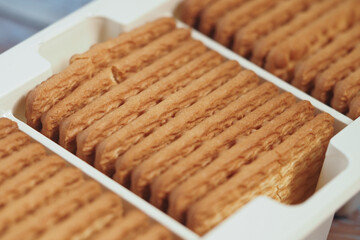 Delicious golden biscuits neatly arranged in a container