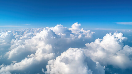 A serene view of fluffy white clouds against a bright blue sky, creating a peaceful and tranquil atmosphere.