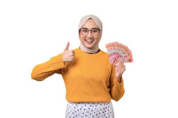 Beautiful smiling Asian girl wearing hijab holding money banknotes and showing thumbs up isolated on transparent background