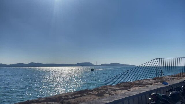 Calm sea and parked bikes on Kish Island Iran under clear blue sky