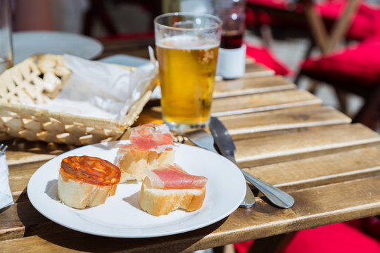 Spanish tapas and glass of beer outdoor, Spain