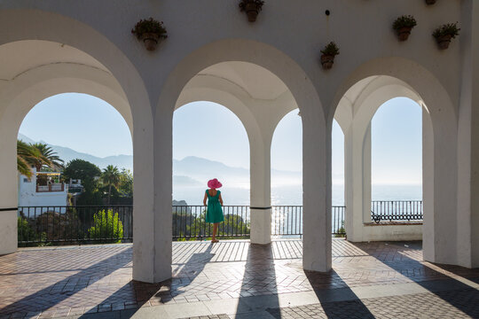Woman standing in a archway, Balcon de Europa, Nerja, Costa del Sol, Spain