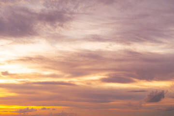 Sunset landscape with brilliant orange clouds and fading twilight light over calm scenery.