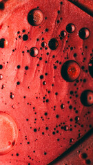 Shiny flow. Paint mix. Defocused red bronze color ink water bubbles fluid essence round drops...