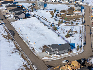 Snowy residential area with a house in the middle