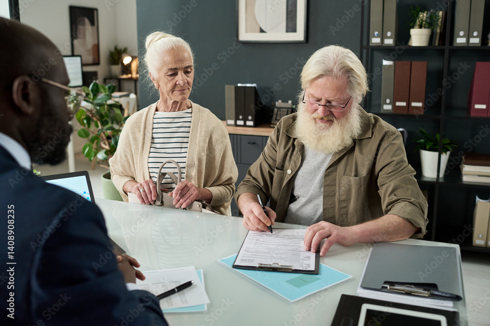 Poster senior man signing contract while having consultation with financial manager in office