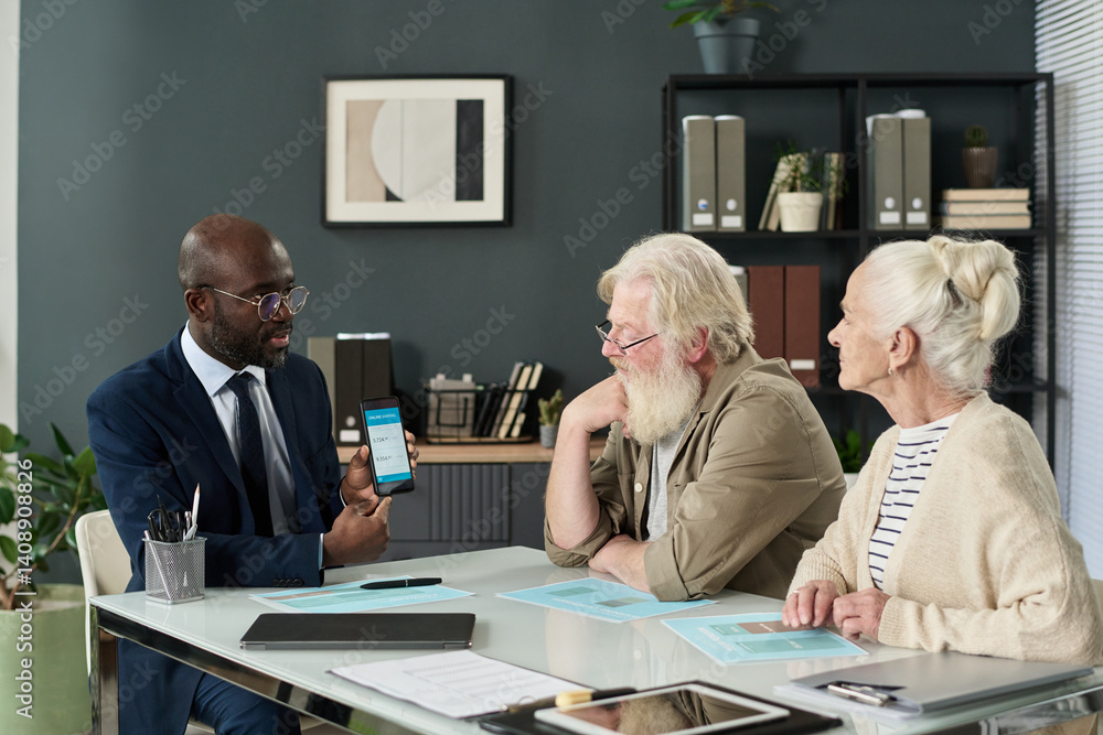 Aufkleber financial agent teaching how to learn banking app to senior couple during their meeting in office